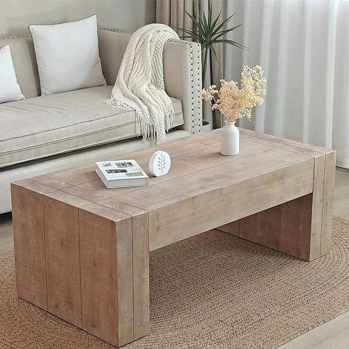 Minimalist block-style wood coffee table with natural grain texture, styled with neutral decor in an Organic Modern living room.