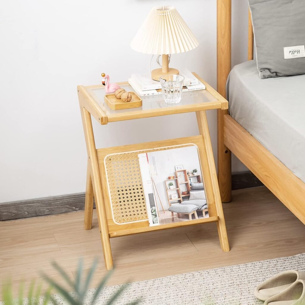 Minimalist bamboo nightstand with lower rattan magazine rack, styled with a pleated shade table lamp and small decorative accents.