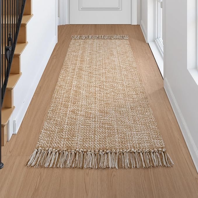 Woven natural fiber runner rug with fringe ends, adding warmth and texture to a minimalist Japandi kitchen hallway.