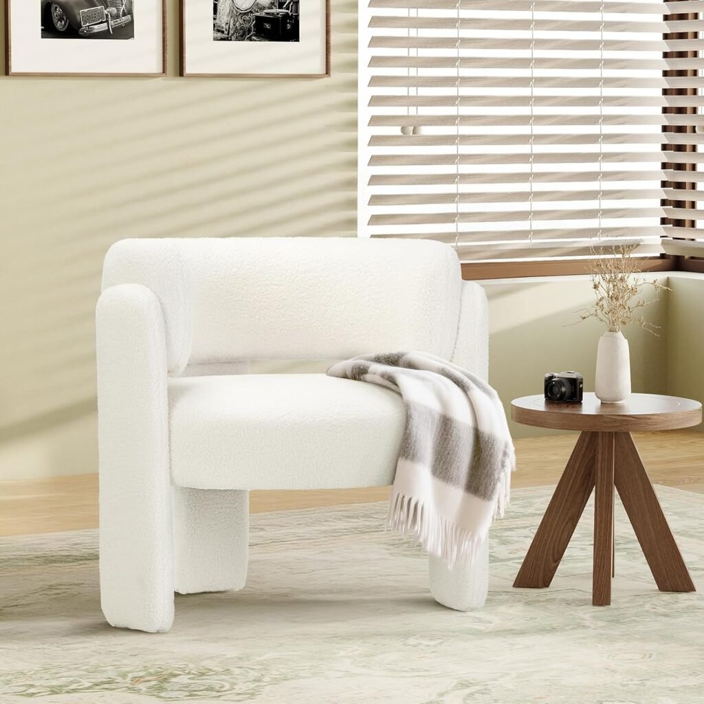 White boucle Japandi accent chair with rounded modern silhouette, styled with a neutral throw on a light rug.