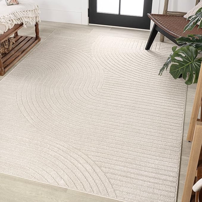 Beige textured area rug with subtle wave patterns, styled in a Japandi entryway with natural wood accents.
