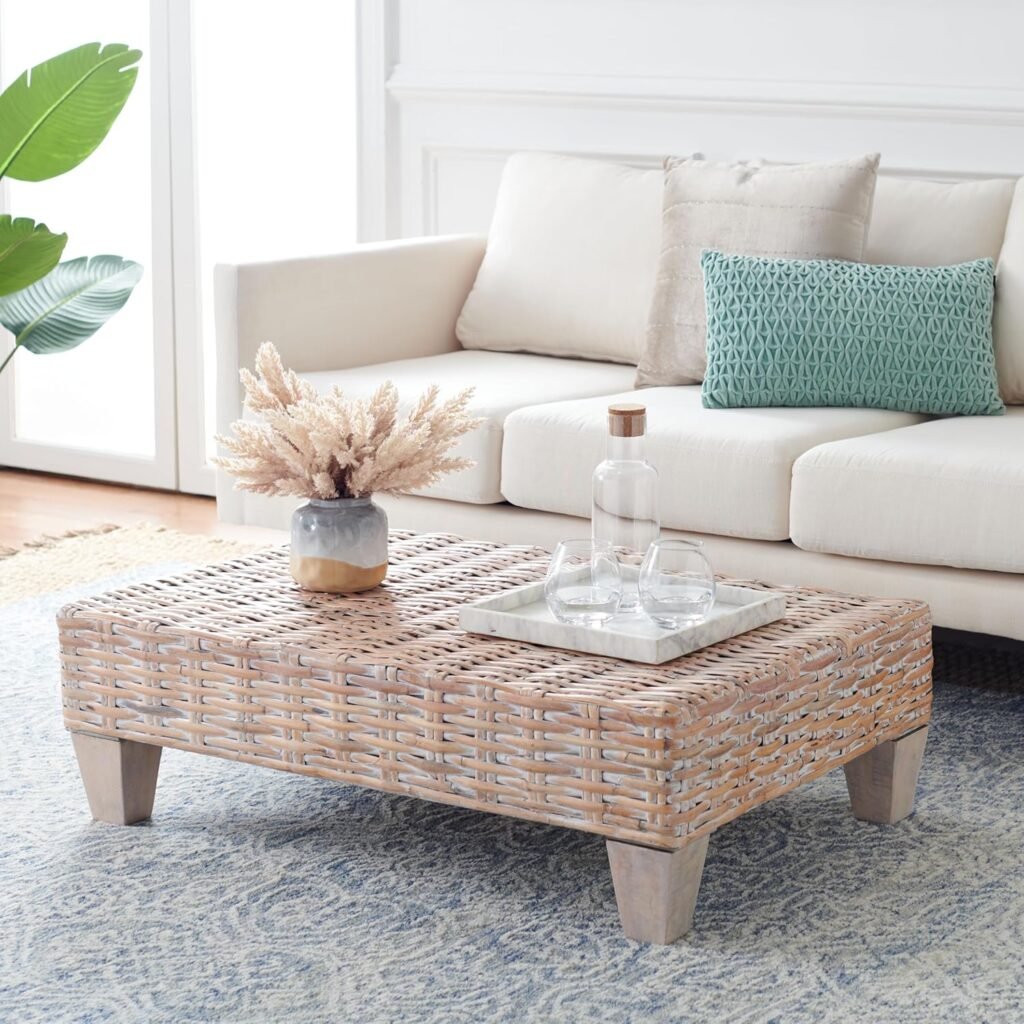 coastal modern woven rattan coffee table with decorative vase and glassware in bright living room