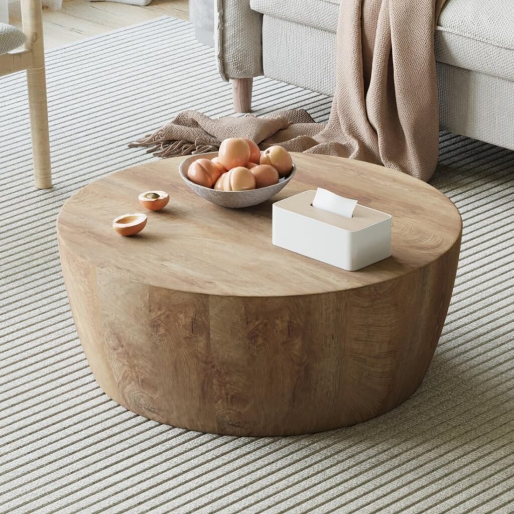 minimal rounded solid wood drum coffee table with neutral styling in organic coastal living room