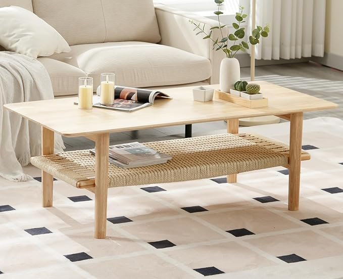Light wood coffee table with a woven lower shelf, styled with candles and decor in a cozy Organic Modern living room.