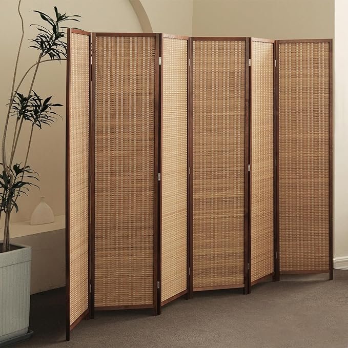 Tall folding rattan room divider with wooden frame in a minimalist living room corner for Japandi-inspired interiors.