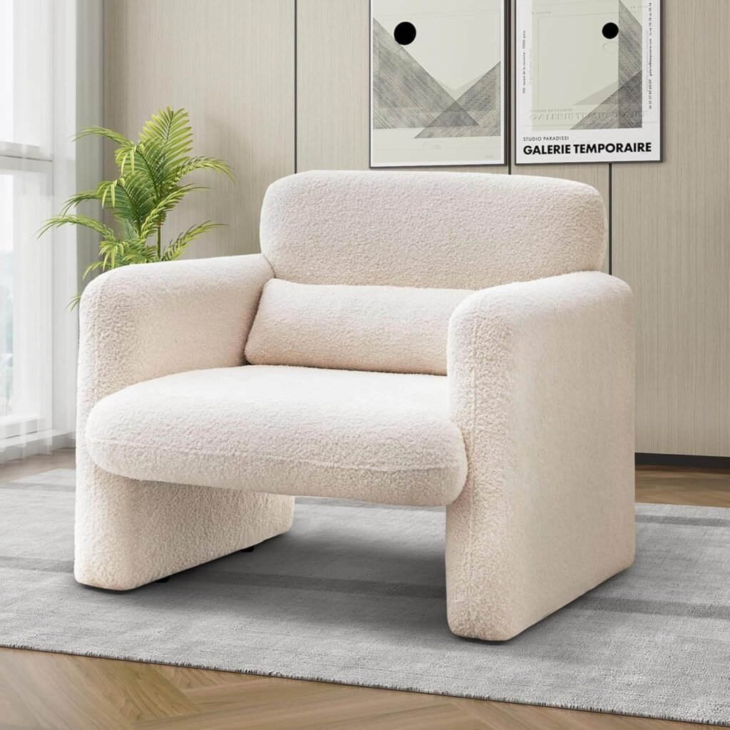 Modern Japandi accent chair with soft white bouclé fabric and rounded edges in a minimalist living space.