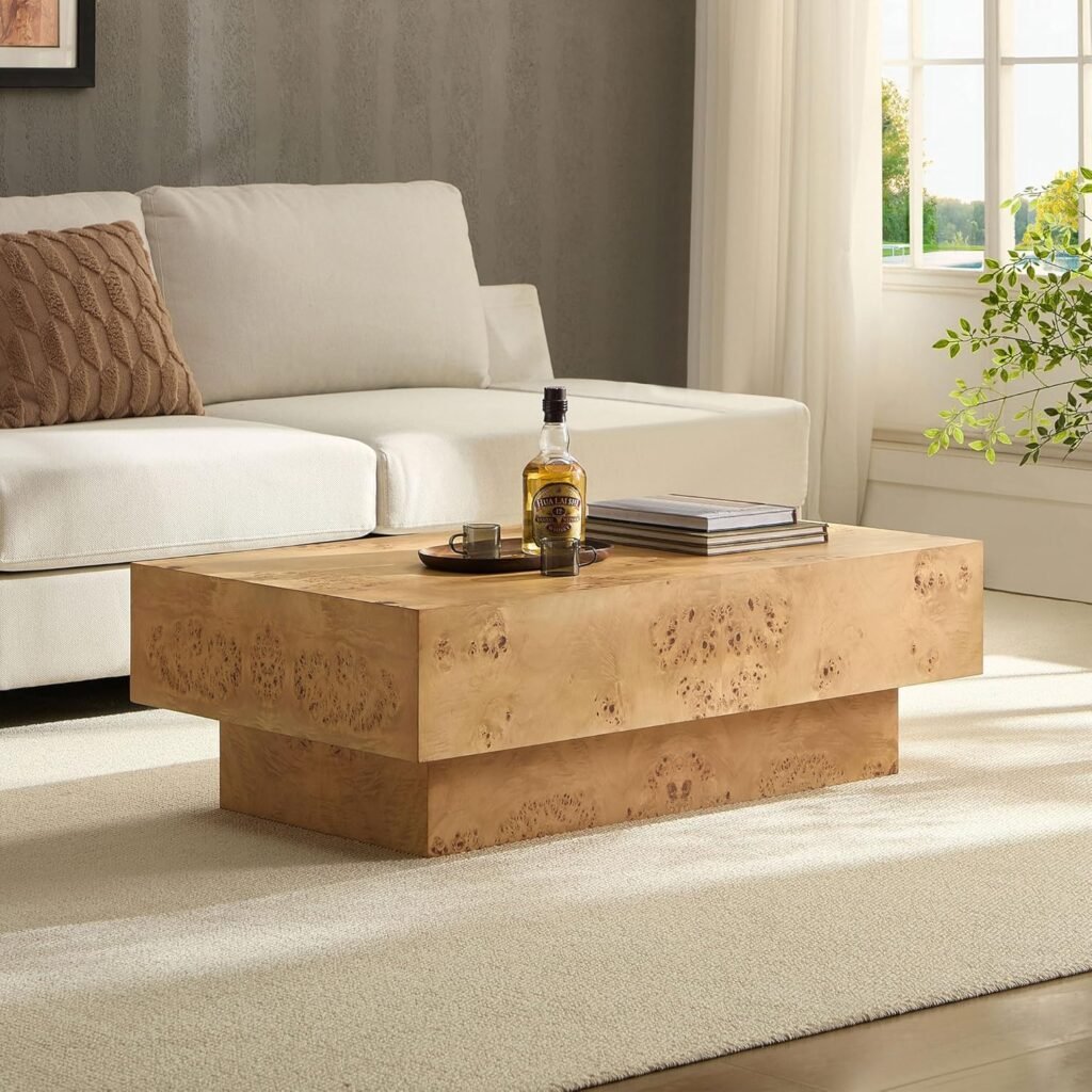 Block-style Japandi coffee table made from burl wood, styled with books and a tray, placed in a modern neutral living space.