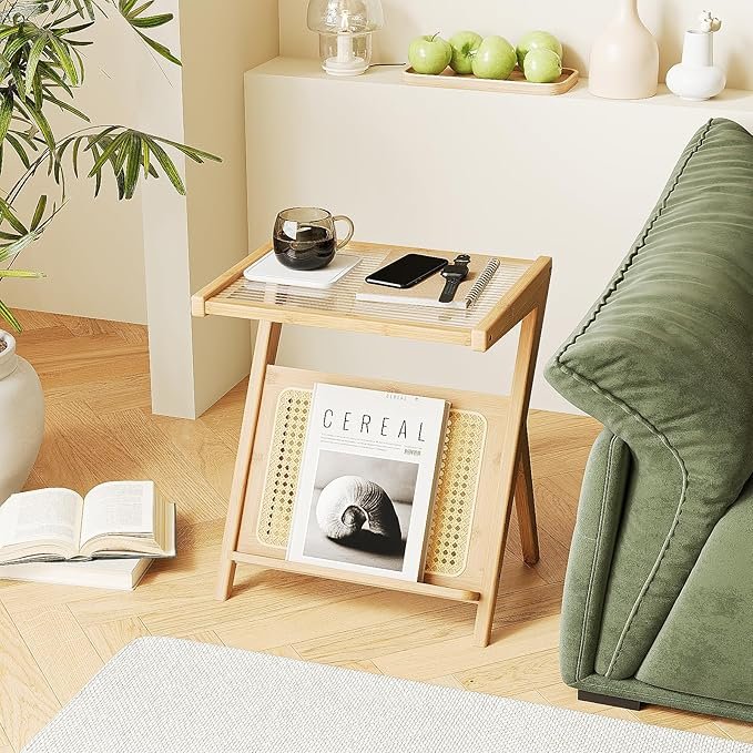Minimalist light wood side table with cane magazine rack styled next to a green sofa in a Japandi living room.