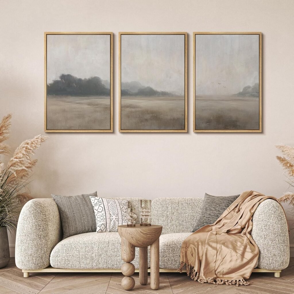 organic modern living room with neutral sofa, fall throw, and muted landscape wall art