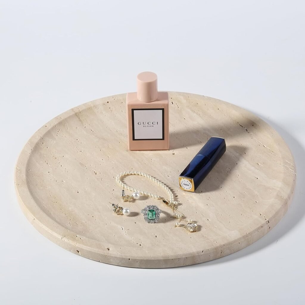 round travertine catchall tray styled with perfume, jewelry, and lipstick for minimal fall decor