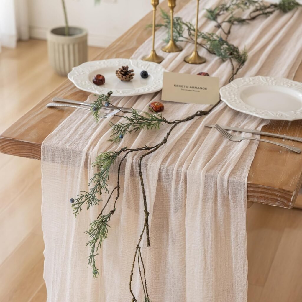 neutral linen table runner styled with greenery and brass candleholders for fall tablescape