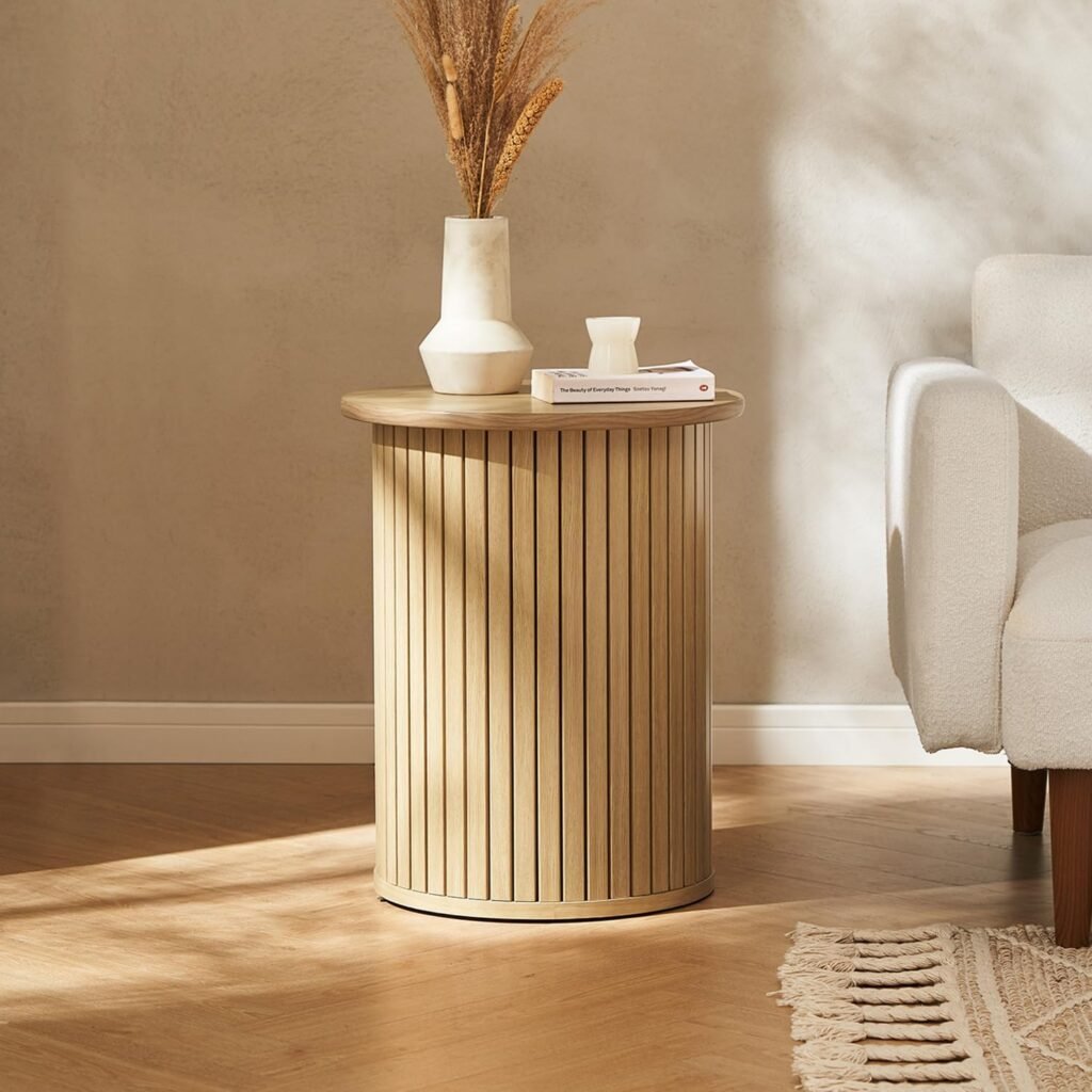 Japandi-inspired cylindrical wood side table with vertical slat design, styled with ceramic vase and dried flowers.