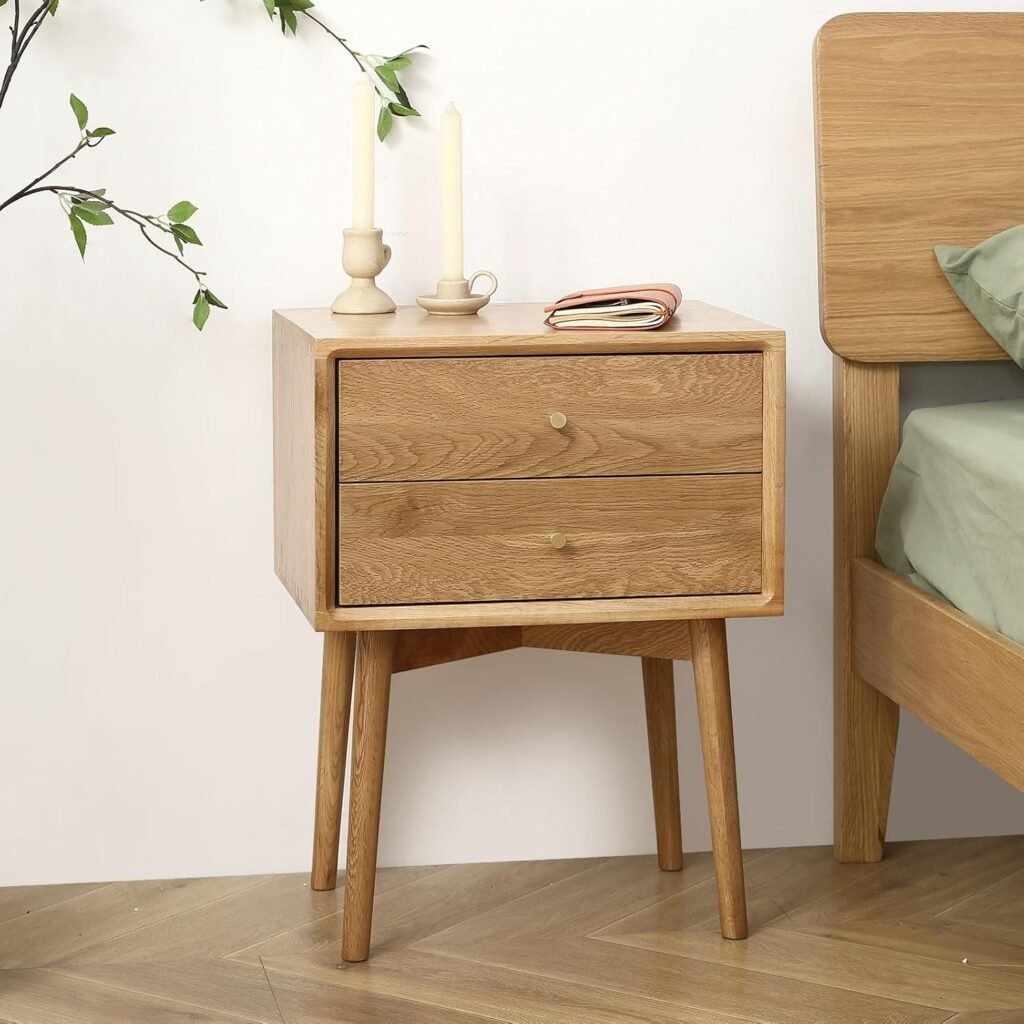Minimalist wooden Japandi nightstand with two drawers and angled legs, styled with candles in a bedroom setting.