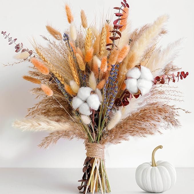 Elegant bouquet of pampas grass, cotton stems, and dried florals in autumn tones tied with twine.