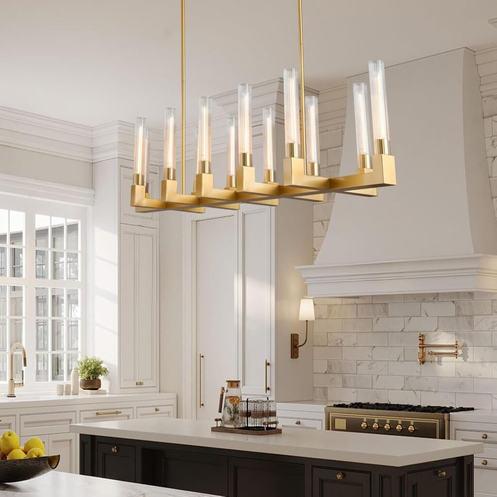gold modern chandelier with tall glass shades hanging over a luxury minimalist kitchen island
