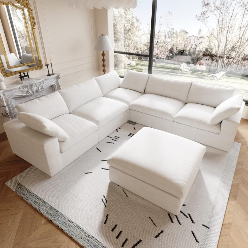oversized white sectional sofa with ottoman in a bright living room with modern luxury details