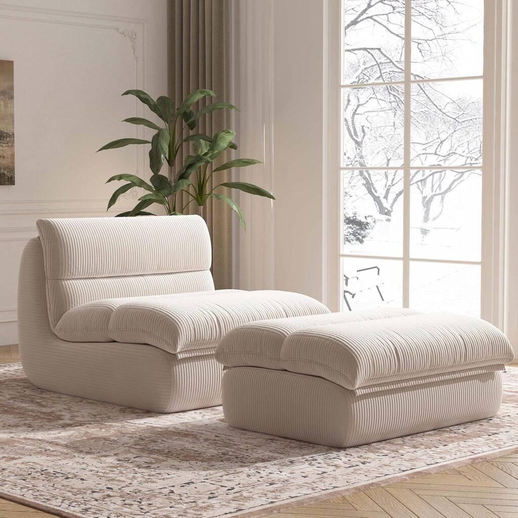 sculptural cream accent chair with matching ottoman in front of tall windows and layered curtains