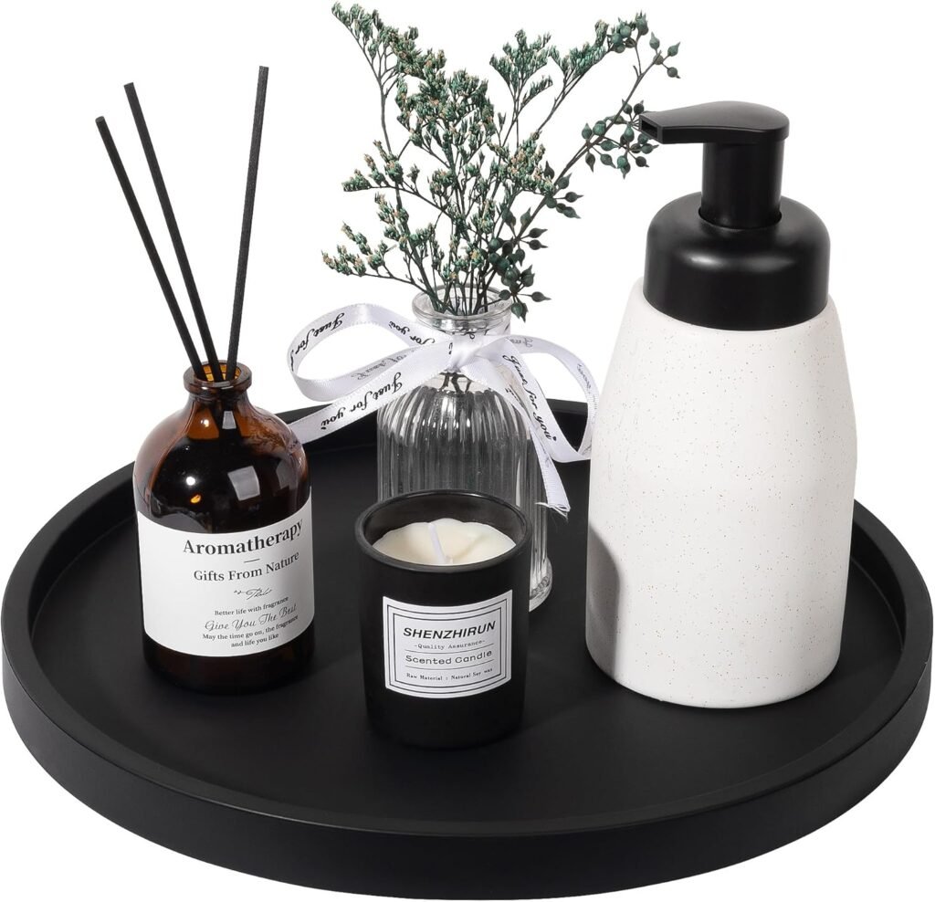 black round tray styled with diffuser, candle, and ceramic soap dispenser in luxury minimalist style